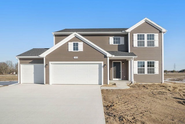 traditional-style house featuring driveway and an attached garage