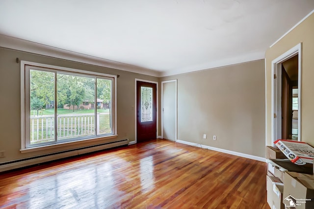 entryway with baseboards, baseboard heating, and wood finished floors