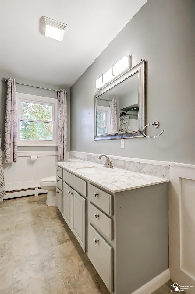 full bathroom featuring a baseboard radiator, vanity, and toilet