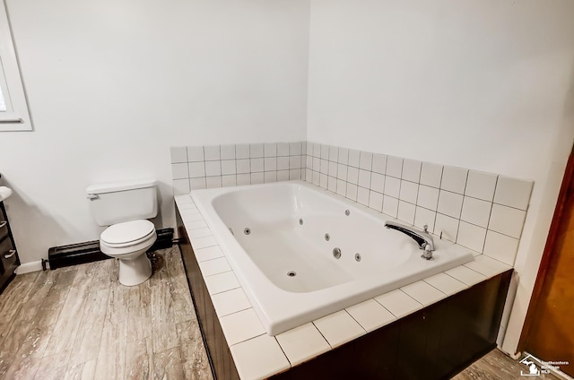 full bathroom with toilet, a jetted tub, and wood finished floors