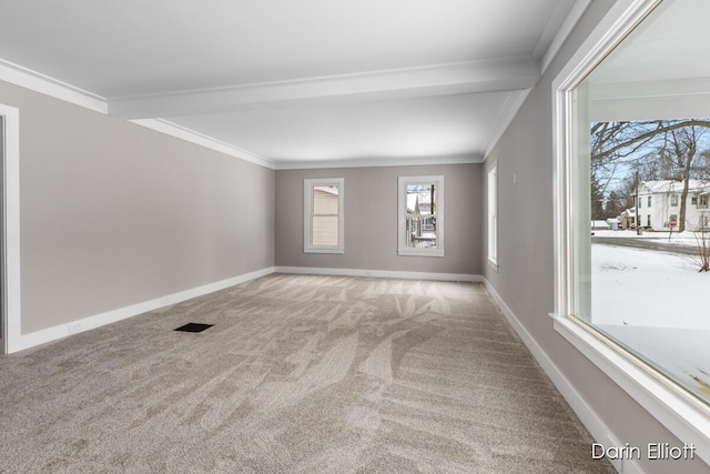 empty room featuring light colored carpet, crown molding, and baseboards