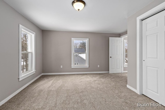 unfurnished bedroom featuring carpet floors and baseboards