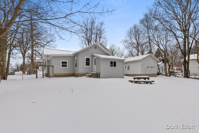 view of snow covered rear of property