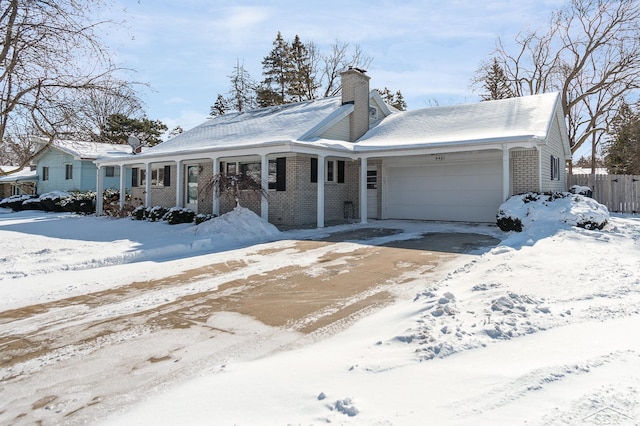 view of front of home with a garage, brick siding, a chimney, and a porch