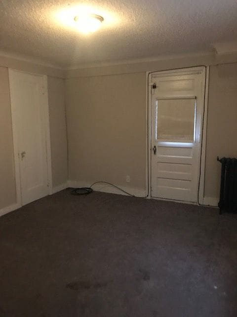 spare room with a textured ceiling