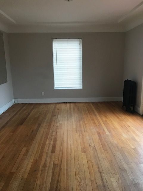 spare room featuring light wood-style floors and baseboards