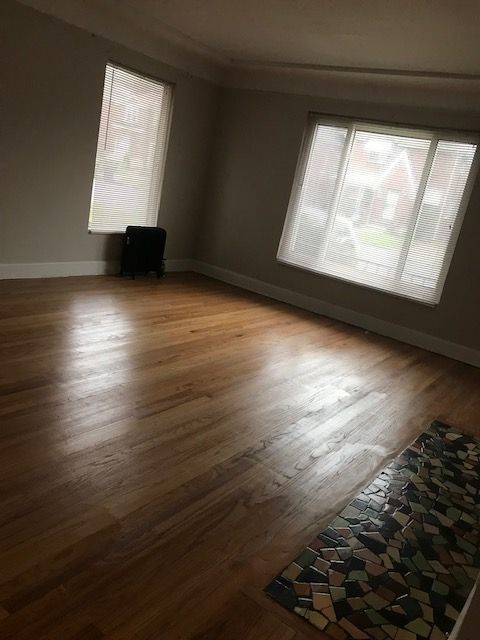 empty room with baseboards and wood finished floors