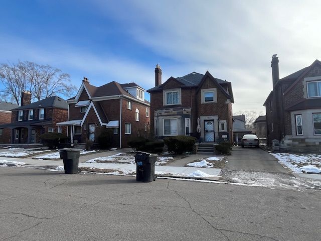 view of front of property featuring a residential view and brick siding