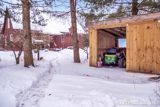 yard covered in snow featuring a carport