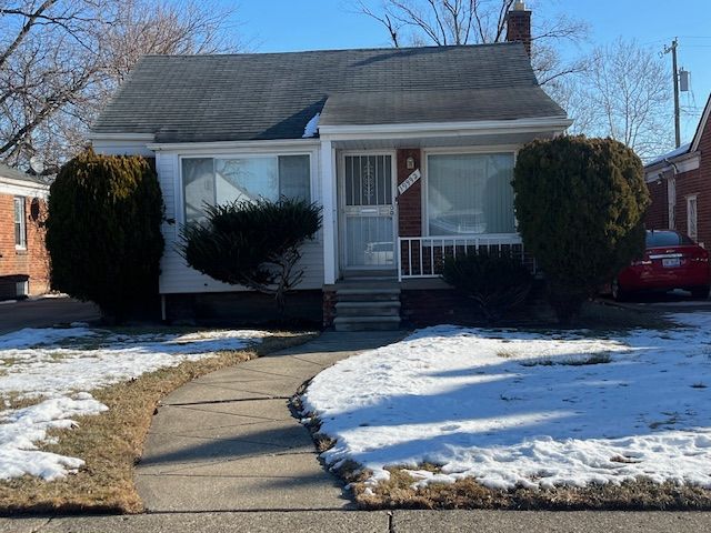 view of front of home featuring entry steps, a chimney, and roof with shingles