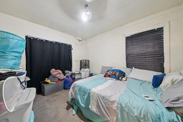 bedroom with light colored carpet and a textured ceiling