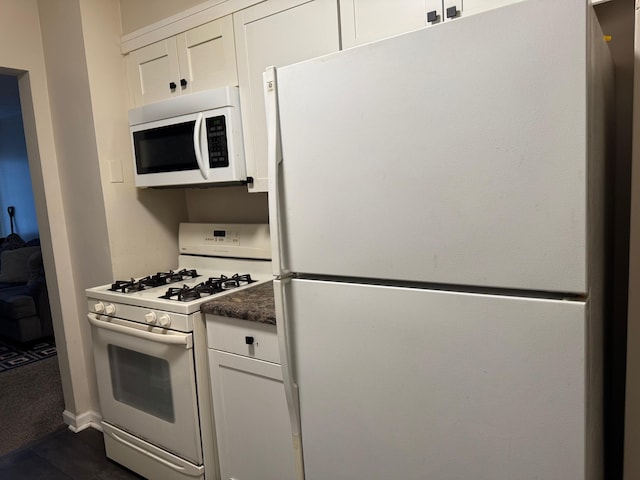 kitchen featuring white appliances and white cabinets