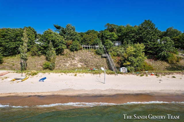 exterior space with a water view and a beach view