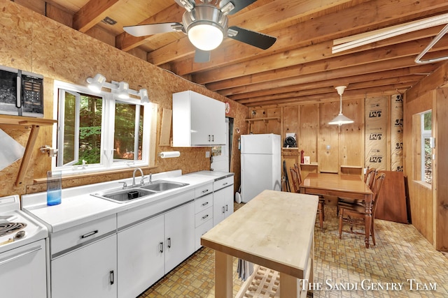 kitchen with light countertops, white appliances, white cabinetry, and hanging light fixtures