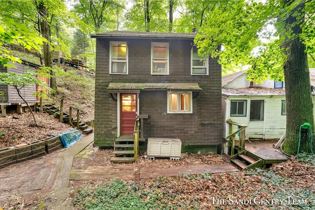 rear view of house featuring entry steps