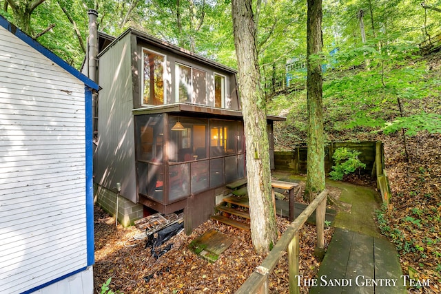 back of house featuring a sunroom