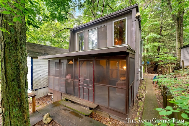 view of outbuilding featuring a sunroom