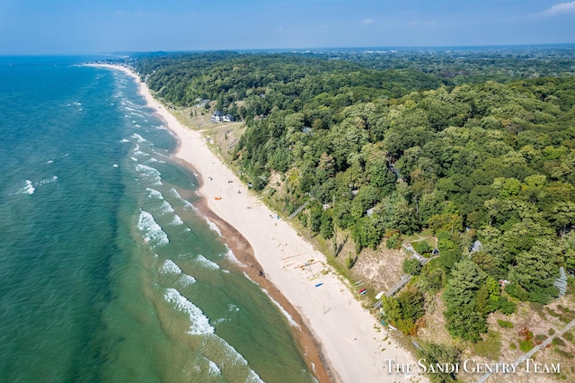 aerial view with a water view, a beach view, and a wooded view