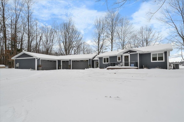 view of front of house with a garage and central AC