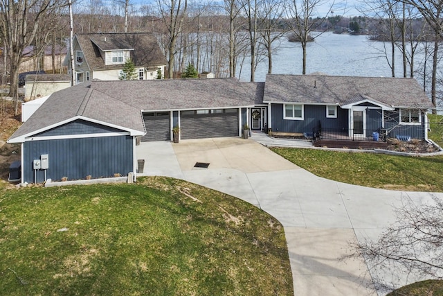 9356 Miramichi Dr, Evart, MI 49631 - view of front of house featuring an attached garage, a front yard, a water view, and concrete driveway