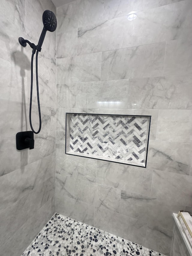 bathroom with a tile shower