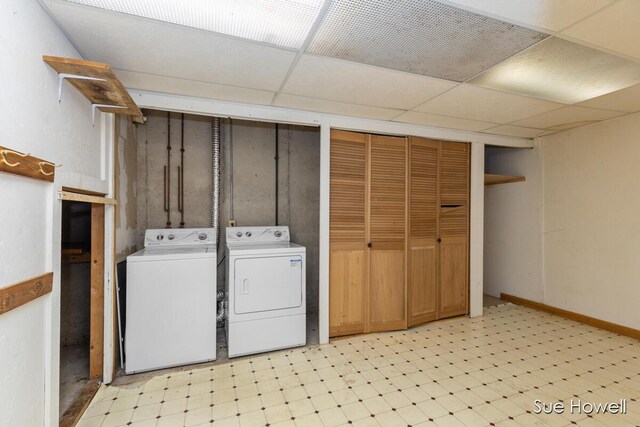 washroom with light floors, laundry area, and washing machine and clothes dryer