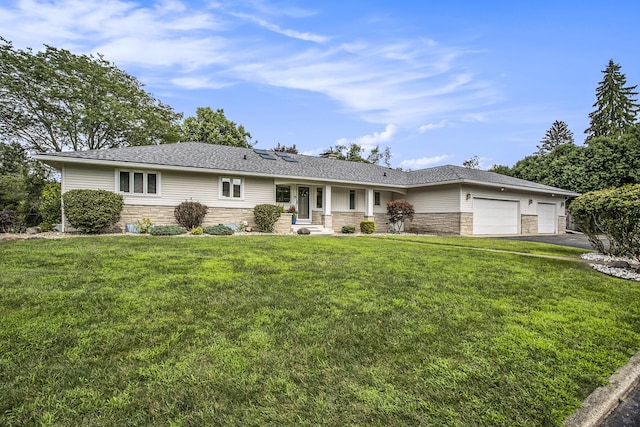 single story home featuring an attached garage, stone siding, a front yard, and driveway