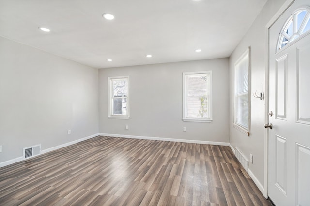 interior space featuring recessed lighting, dark wood finished floors, and baseboards