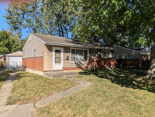 view of front of house featuring an outbuilding, brick siding, a garage, driveway, and a front lawn