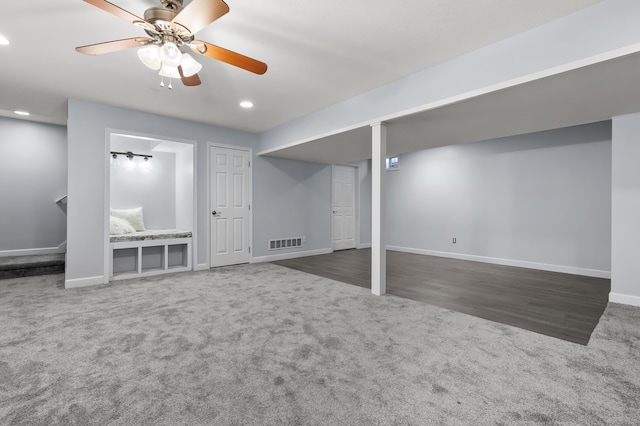 finished basement with dark colored carpet, recessed lighting, visible vents, a ceiling fan, and baseboards