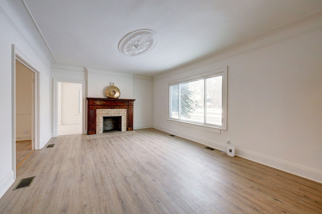 9543 W Outer Dr, Detroit, MI 48223 - unfurnished living room with light wood-type flooring, visible vents, and a fireplace