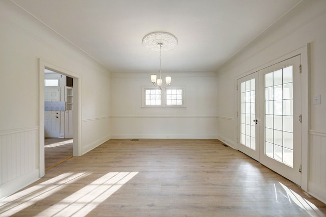 9543 W Outer Dr, Detroit, MI 48223 - unfurnished dining area with an inviting chandelier, french doors, and light wood-type flooring