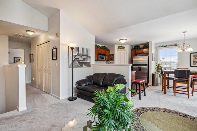 living area with lofted ceiling, light colored carpet, and baseboards