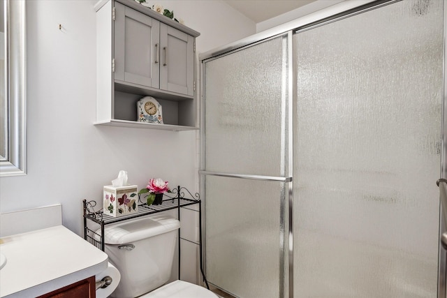 full bathroom featuring toilet, an enclosed shower, and vanity