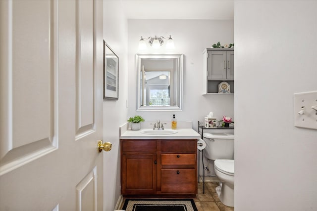 bathroom featuring vanity and toilet