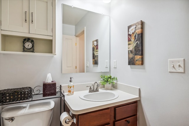 half bathroom with toilet and vanity