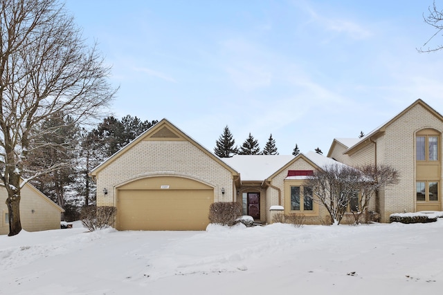 view of front facade with a garage and brick siding