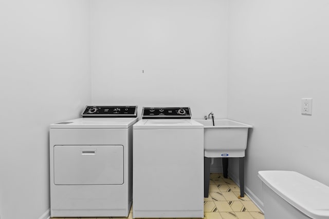 laundry area with laundry area, baseboards, and separate washer and dryer