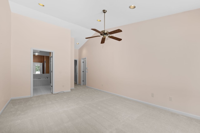 spare room with high vaulted ceiling, recessed lighting, light carpet, and baseboards