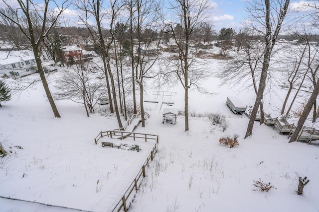 yard covered in snow featuring a garage