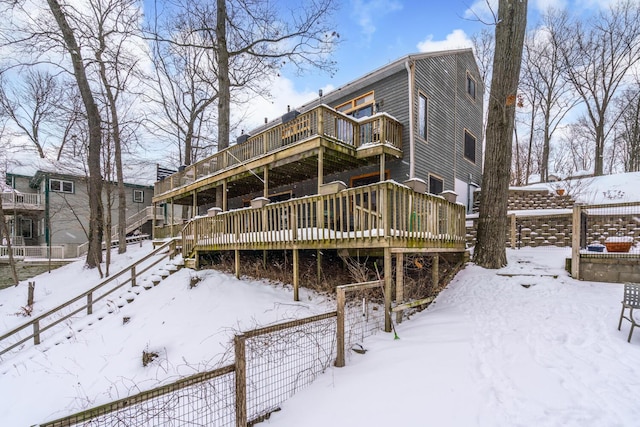 snow covered property with a deck