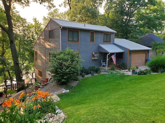 view of front of property featuring metal roof, a front lawn, a standing seam roof, and an attached garage