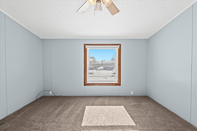 unfurnished room with carpet floors, a ceiling fan, and a textured ceiling