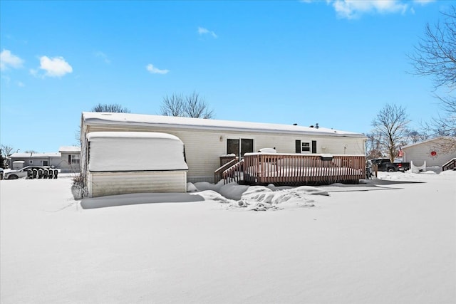 snow covered property featuring a wooden deck