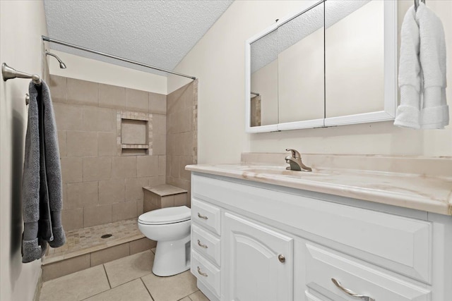 full bath with tiled shower, toilet, tile patterned flooring, a textured ceiling, and vanity