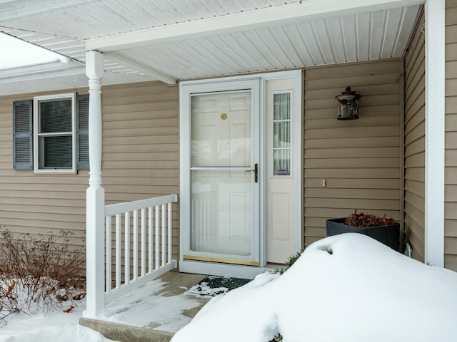 view of snow covered property entrance