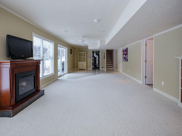 unfurnished living room with ornamental molding, light colored carpet, a fireplace, and stairs