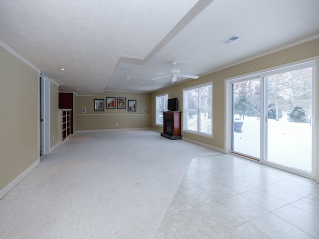 unfurnished living room featuring light carpet, baseboards, visible vents, and crown molding