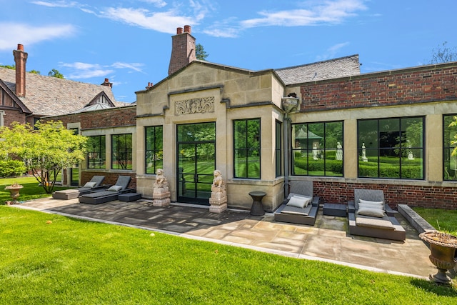 1771 Balmoral Dr, Detroit, MI 48203 - back of property featuring a yard, a patio, a chimney, and outdoor lounge area