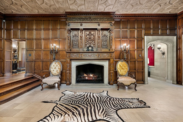 1771 Balmoral Dr, Detroit, MI 48203 - sitting room featuring an ornate ceiling, wooden walls, a warm lit fireplace, and arched walkways